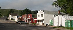 Street with half a dozen one- and two-story buildings