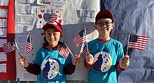 Two students holding flags
