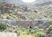 Narrow Route 66 stone bridge leading to Oatman