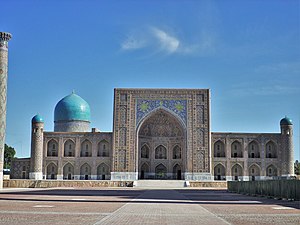 Front facade of the madrasa in the foreground