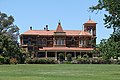 Rippon Lea, Elsternwick, Victoria. Designed 1868 by Reed & Barnes. A Lombardic Romanesque version of the style in polychromatic brick.[37]