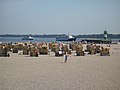 Excursion boats and roofed wicker beach chairs