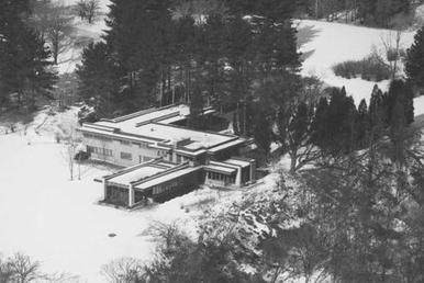 Aerial view of house shortly after construction