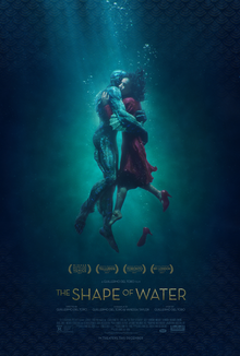 Underwater, a woman and a humanoid amphibian creature embrace.