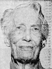 An older white woman, smiling, with short white hair