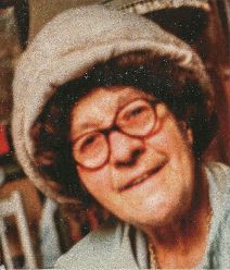 Elderly woman in hat and spectacles