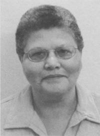 headshot of Elfreda Chatman a woman approximately middle age looking face on at the camera, with glasses and a short afro