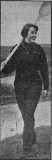 Black and white photo of a woman holding a canoe paddle.