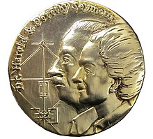 A bronze medal etched with the profile of a man and a woman, along with their names "Dr. Harold and Dorothy Seymour" and the outline of a baseball field.