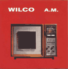 An old fashioned A.M. radio on a red background. The artist name and album title appear above it.