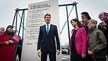 Ed Miliband and Labour campaigners stand infront of the EdStone, which is significantly taller than anybody in the photograph.