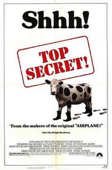 In a white background, a cow with boots leaving behind footprints, with the film's title in red inside a Red and white rectangle. The film's top tagline reads "Shhh!" with an fine print mentioning "(Not the Wright Brothers)", referencing the directors and writers who also worked on one of their previous works, "Airplane!".