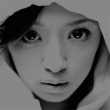 A black-and-white up-close shot of Ayumi Hamasaki's face looking into the camera.