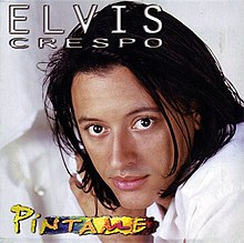 Close-up of Elvis Crespo facing the camera from his right wearing a white shirt.