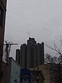 Both Towers are tall enough that they extend past the Victorian-Era Apartment buildings in the area. Taken from Villa Avenue.