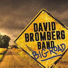 A country road, with a road sign saying "David Bromberg Band" and "Big Road"