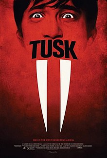 On top of a red background, an outline of the face of a scared man with the film's logo in his mouth and a pair of walrus tusks hanging below, while the billing block and release date remain at the bottom.