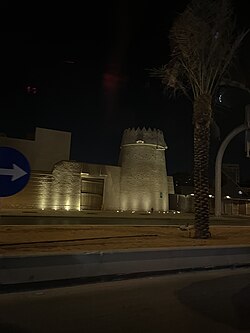 A mudbrick watchtower attached with a gate of the former city walls in ad-Doho, 2024