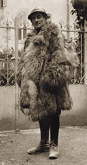 middle aged man in French military uniform wrapped up in fur overcoat