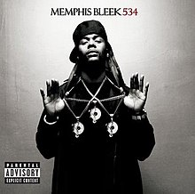 A grayscale photo of Memphis Bleek, showing him wearing three Roc-A-Fella pendants, arranged to form a triangle. The text "Memphis Bleek 534" is placed above his head.