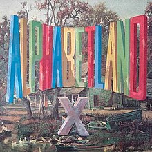 A painting of a colorful logo with tall letters reading "ALPHABETLAND" in a forest with a lake that has a grey "X" below it on the ground