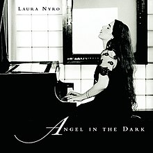 A black-and-white profile photo of Nyro at a piano