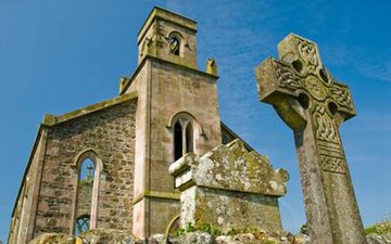 Abandoned St Colmac Church with ancient Celtic Cross