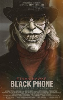 A man with a white painted face wears a black top hat, glasses, the bottom half of a white mask with an exaggerated smile, a red turtleneck sweater, and a black jacket; the poster is tinted in film grain.