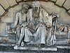 A relief statue on the front wall of Strand School