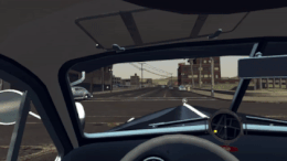 The player (in first-person) drives a car through the streets of Los Angeles.