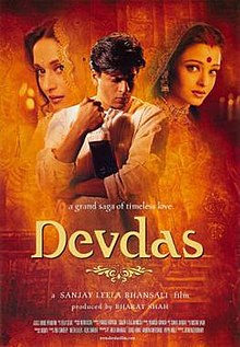 The theatrical poster of Devdas, featuring the leading cast (Shah Rukh Khan, Aishwarya Rai and Madhuri Dixit). Khan features on the middle, holding a bottle of alcohol, while Rai and Dixit on the right and left of him, respectively.