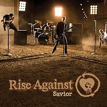 Cover art for the single "Savior" by Rise Against. The cover features a picture of three guitar players and one drummer, performing in a dirt lot.