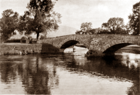 old stone bridge, double-arched, across a river