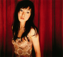 The cover image features Miki Nakatani in a patterned tank top against a red, curtained backdrop. Cover image is textless.