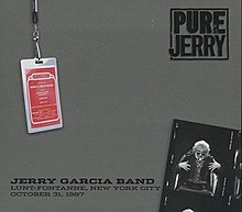 A photo of Jerry Garcia as a stage magician conjuring a guitar from out of a hat, and a backstage pass for the Jerry Garcia Band