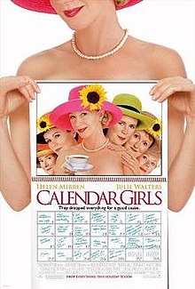 A nude woman holding a calendar to cover her body, and the calendar shows a picture of her and several other women