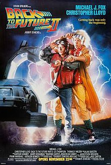 Michael J. Fox and Christopher Lloyd stepping out of a partially-visible DeLorean vehicle, looking astonishingly at their wristwatches. The logo of the film appears on the top left, while the tagline "Getting back was only the beginning" appears on the top right.