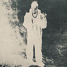 Cover art for Éxodo, which depicts a distorted inverted-color image of Peso Pluma holding up the peace sign with both of his hands.