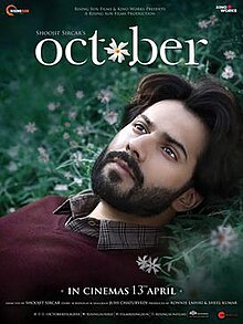 The poster features face of Varun Dhawan laid on the grass. The film title appears on top.