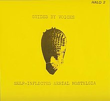 A flat yellow background with a strange mask-like image in the middle and the band name and album title printed in distressed, typewriter font.
