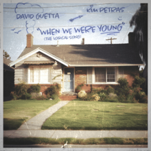 An old image of a house with different drawings in blue ink (including a chimney smoke, birds, an arrow, and a smiley face). The word "Young" in the song's title is underlined while the "i" in Kim Petras's name has a hard on it.